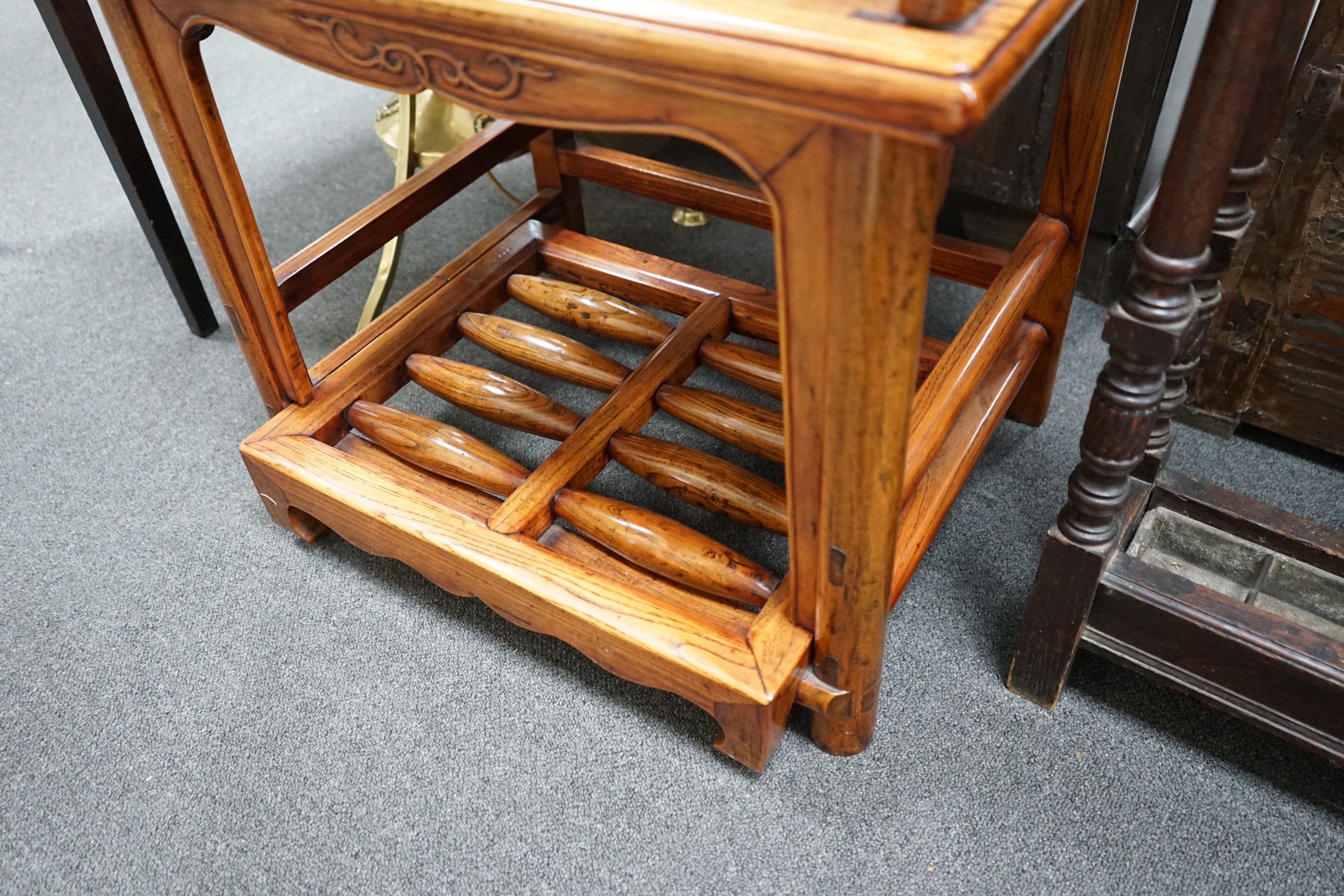 A pair of Chinese elm armchairs with roller footrests, width 57cm, depth 53cm, height 89cm